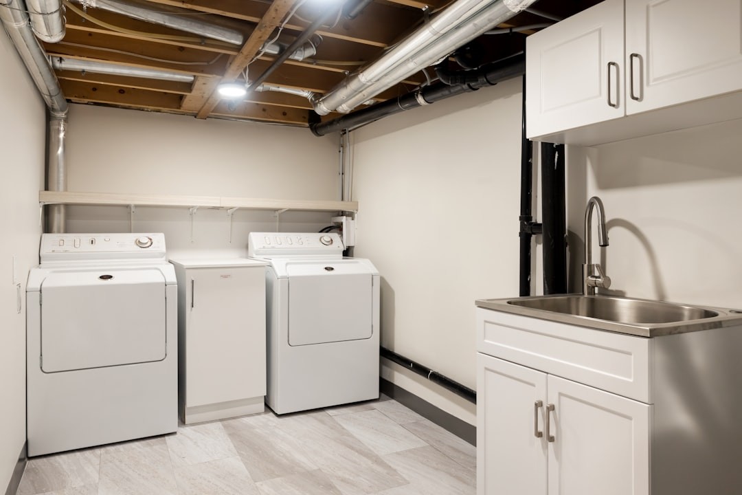 a laundry room with washers and dryers in it
